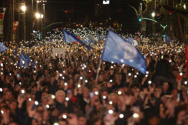 Protesters raise their mobile phones flashlights during an anti-government rally in Tirana, Albania, on Saturday, Nov. 12, 2022. Thousands of Albanian opposition supporters protested against the center-left government's alleged corruption and this year's significant rise of prices due to the cost-of-living crisis. (AP Photo/Franc Zhurda)