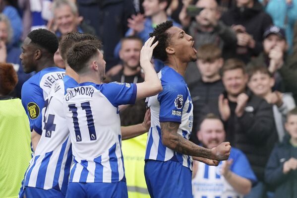 Brighton and Hove Albion's Joao Pedro, right, celebrates after scoring the opening goal of the game during the Premier League match between Brighton & Hove Albion and Aston Villa, at the American Express Stadium in Brighton, England, Sunday May 5, 2024. (Gareth Fuller/PA via AP)