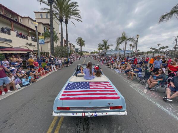 Actress Scarlett Abinante heads up Main Street during the 118th Huntington Beach 4th of July Parade in Huntington Beach, Calif., on Monday, July 4, 2022. (Jeff Gritchen/The Orange County Register via AP)