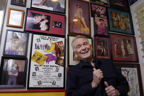 Costume and fashion designer Bob Mackie poses amongst memorabilia from his career, Wednesday, Oct. 20, 2021, at his home in Palm Springs, Calif. A new book, "The Art of Bob Mackie," spans the 60-year career of the Oscar and Emmy Award winning designer. (AP Photo/Chris Pizzello)
