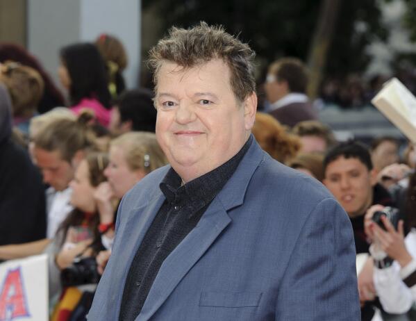 FILE - Robbie Coltrane arrives in Trafalgar Square, central London, for the world premiere of "Harry Potter and The Deathly Hallows: Part 2," the last film in the series on July 7, 2011. Coltrane, who played a forensic psychologist on TV series “Cracker” and Hagrid in the “Harry Potter” movies, has died. Coltrane’s agent Belinda Wright said he died Friday at a hospital in Scotland. He was 72. (AP Photo/Jonathan Short, File)