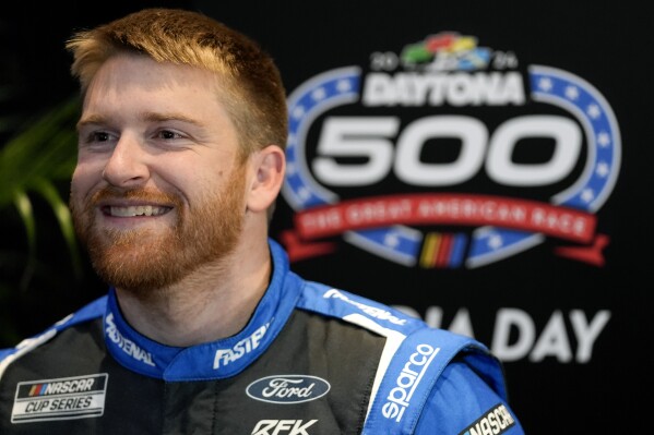 Chris Buescher answers questions during in interview at NASCAR Daytona 500 auto racing media day at Daytona International Speedway, Wednesday, Feb. 14, 2024, in Daytona Beach, Fla. (AP Photo/John Raoux)