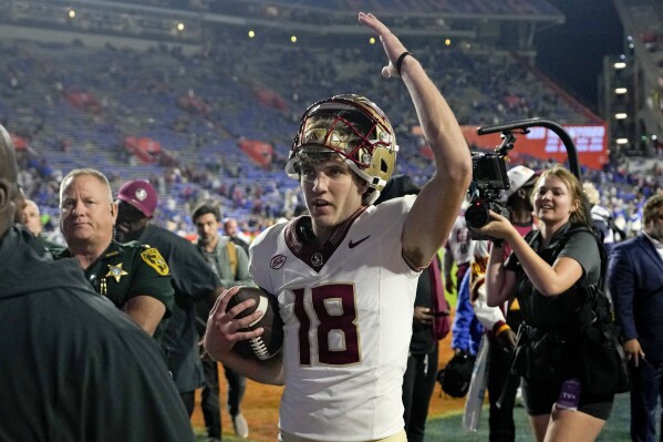Florida State quarterback Tate Rodemaker (18) waves to fans as he leaves the field after the team's win over Florida in an NCAA college football game Saturday, Nov. 25, 2023, in Gainesville, Fla. (AP Photo/John Raoux)