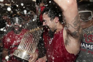Washington Nationals third baseman Anthony Rendon and Adam Eaton celebrate in the locker room after Game 7 of the baseball World Series against the Houston Astros Wednesday, Oct. 30, 2019, in Houston. The Nationals won 6-2 to win the series. (AP Photo/David J. Phillip)
