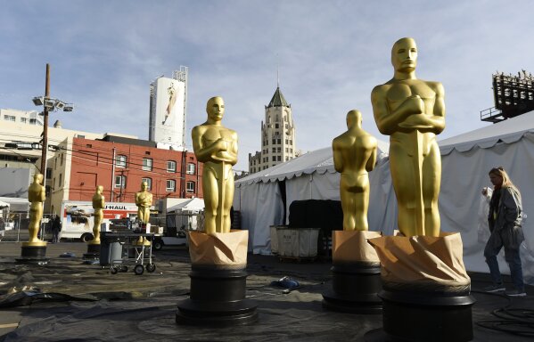 Oscar statues stand outside Hollywood Boulevard in preparation for Sunday's 92nd Academy Awards at the Dolby Theatre, Wednesday, Feb. 5, 2020, in Los Angeles. (AP Photo/Chris Pizzello)