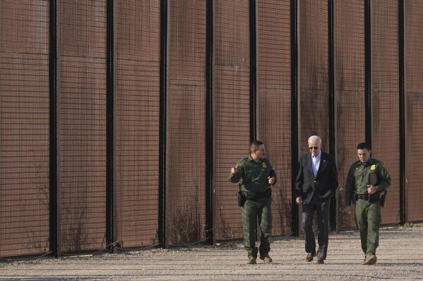 FILE - President Joe Biden walks with U.S. Border Patrol agents along a stretch of the U.S.-Mexico border in El Paso Texas, Sunday, Jan. 8, 2023. A new poll by The Associated Press-NORC Center for Public Affairs Research shows some support for changing the number of immigrants and asylum-seekers allowed into the country. About 4 in 10 U.S. adults say the level of immigration and asylum-seekers should be lowered, while about 2 in 10 say they should be higher, according to the poll. About a third want the numbers to remain the same. (AP Photo/Andrew Harnik, File)