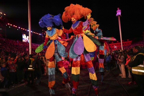 Dancers parade through Place Massena during the opening ceremony of 151st edition of the Nice Carnival in Nice, southern France, Saturday, Feb. 17, 2024. (AP Photo/Daniel Cole)