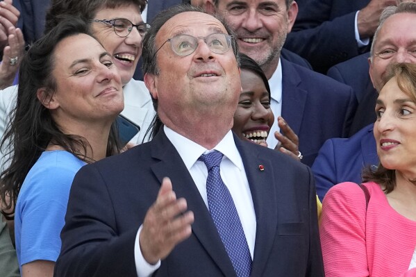 Former French President Francois Hollande looks up as he poses with newly elected parliament members of the Socialist party, at the National Assembly, Tuesday, July 9, 2024 in Paris. French voters have given a broad leftist coalition the most parliamentary seats in a pivotal legislative election that has kept the far right from power but has put France in the unprecedented position of having no dominant political bloc in parliament. (ĢӰԺ Photo/Michel Euler)