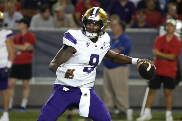 Washington quarterback Michael Penix Jr. looks to pass against Arizona during the first half of an NCAA college football game, Saturday, Sept. 30, 2023, in Tucson, Ariz. (AP Photo/Rick Scuteri)