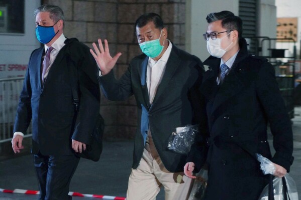 FILE - Hong Kong pro-democracy media tycoon Jimmy Lai, center, leaves the Hight Court after being granted bail in Hong Kong on Dec. 23, 2020. The son of jailed Hong Kong media mogul and pro-democracy activist Jimmy Lai will meet with Britain’s foreign secretary on Tuesday to lobby for the U.K.'s help in securing his release from prison. Lai faces a long-delayed trial next week over charges he violated sweeping national security laws that Beijing imposed on the city in the wake of mass pro-democracy protests. (AP Photo/Vincent Yu, File)