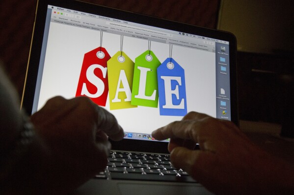 FILE - A person searches the internet for sales, on Dec. 12, 2016, in Miami. An internet trade group on Thursday, June 6, 2024, sued the state of Georgia to block a law requiring sites to gather data on high-volume sellers who advertise goods online and collect payment in cash or some other offline method. (AP Photo/Wilfredo Lee, File)