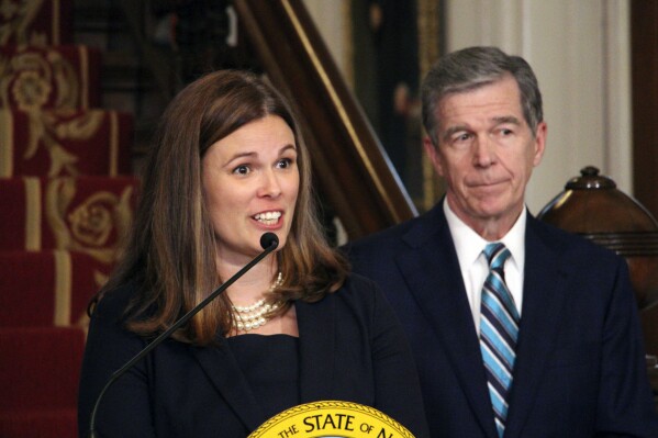 North Carolina Gov. Roy Cooper, right, appoints State Court of Appeals Judge Allison Riggs, left, to the North Carolina Supreme Court to fill a vacancy, Monday, Sept. 11, 2023, at the Executive Mansion in Raleigh, N.C. (AP Photo/Hannah Schoenbaum)