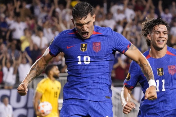 U.S. forward Brandon Vazquez (19) celebrates his game-tying goal against Jamaica with forward Cade Cowell (11) during the second half of a CONCACAF Gold Cup soccer match Saturday, June 24, 2023, in Chicago. (AP Photo/David Banks)