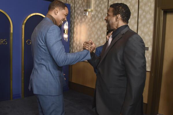 Will Smith, left, and Denzel Washington arrive at the 94th Academy Awards nominees luncheon on Monday, March 7, 2022, in Los Angeles. (Photo by Jordan Strauss/Invision/AP)