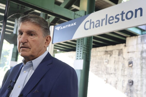 West Virginia Democratic Sen. Joe Manchin speaks with reporters outside the newly renovated Amtrak train station in Charleston, W.Va. on Thursday, Oct. 12, 2023 (AP Photo/Leah Willingham)