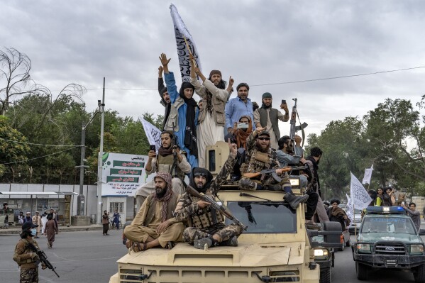 File - Taliban fighters celebrate one year since they seized the Afghan capital, Kabul, in front of the U.S. Embassy in Kabul, Afghanistan, Monday, Aug. 15, 2022. (AP Photo/Ebrahim Noroozi, File)