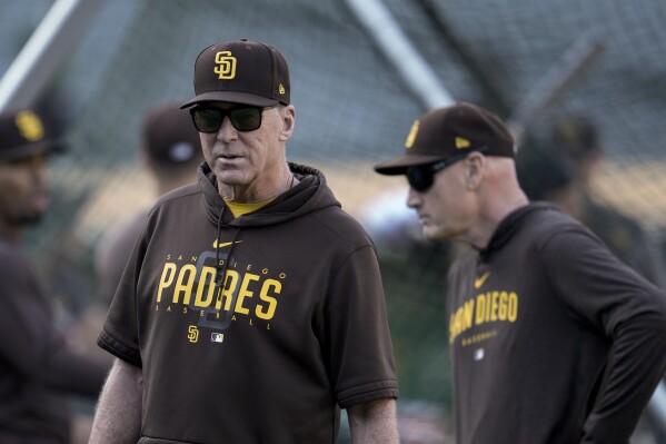 San Diego Padres manager Bob Melvin, left, watches batting practice before the team's baseball game against the Oakland Athletics on Friday, Sept. 15, 2023, in Oakland, Calif. (AP Photo/Godofredo A. Vásquez)