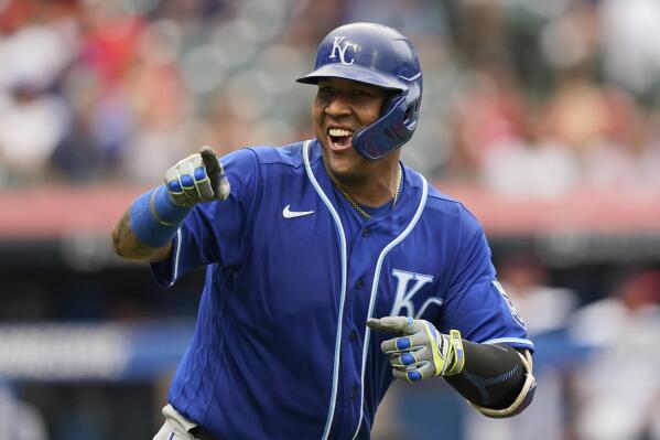 Kansas City Royals' Salvador Perez smiles and points to the dugout after hitting a two-run home run in the fifth inning in the first baseball game of a doubleheader against the Cleveland Indians, Monday, Sept. 20, 2021, in Cleveland. The home run broke Johnny Bench's record for the most home runs in a season by a primary catcher. (AP Photo/Tony Dejak)