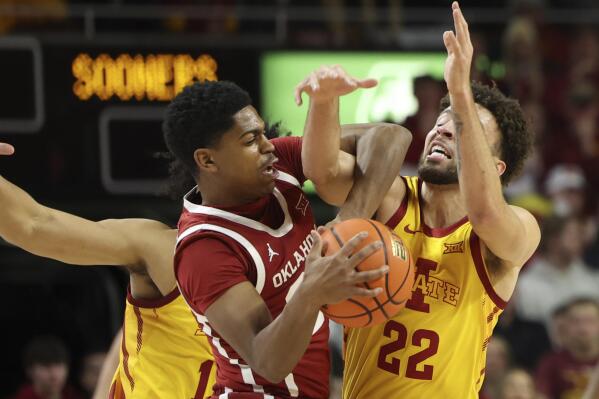 Iowa State guard Gabe Kalscheur (22) gets tangled up with Oklahoma guard Grant Sherfield (25) during the first half of an NCAA college basketball game, Saturday, Feb., 25, 2023, in Ames, Iowa. (AP Photo/Justin Hayworth)