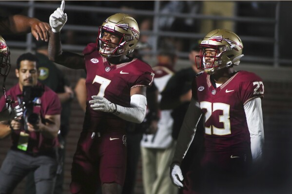 Florida State defensive back Jarrian Jones (7) celebrates his touchdown after intercepting a pass with defensive back Fentrell Cypress II (23) in the third quarter of an NCAA college football game against Southern Mississippi, Saturday, Sept. 9, 2023, in Tallahassee, Fla. FSU won 66-13. (AP Photo/Phil Sears)