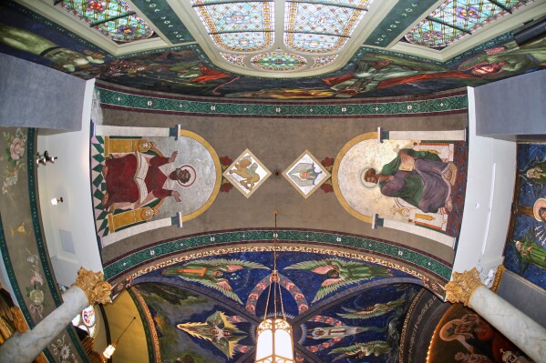 After removal of a 32-foot-high scaffold, murals by Max Vanka depicting St. Mark, left, and St. Matthew, right, are revealed in St. Nicholas Croatian Catholic Church after undergoing preservation efforts in Millvale, Pa., Wednesday, May 28, 2025. (AP Photo/Gene J. Puskar)