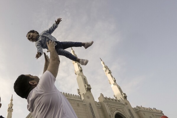 FILE - Muslims celebrate Eid al-Fitr marking the end of the Muslim holy fasting month of Ramadan outside al-Seddik mosque in Cairo, Egypt, Friday, April 21, 2023. (AP Photo/Amr Nabil, File)