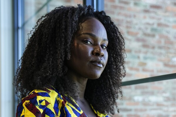 Sophia Danner-Okotie poses for a portrait in her shared workspace Wednesday, Oct. 18, 2023, in Fayetteville, Ga. Danner-Okotie has ambitious plans for her Nigerian-inspired clothing line but a sense of dread has punctured her optimism as she watches a lawsuit try to take down a small venture capital firm that was instrumental to her boutique brand's growth. (AP Photo/John Bazemore)