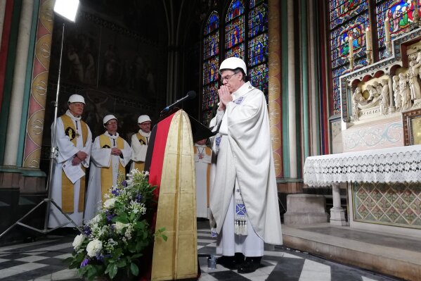 The Archbishop of Paris Michel Aupetit leads the first mass in a side chapel, two months after a devastating fire engulfed the Notre-Dame de Paris cathedral, Saturday June 15, 2019, in Paris. (Karine Perret, Pool via AP)