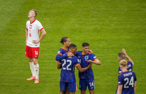 Poland's Adam Buksa, left, reacts after a Group D match between Poland and the Netherlands at the Euro 2024 soccer tournament in Hamburg, Germany, Sunday, June 16, 2024. (AP Photo/Petr Josek)