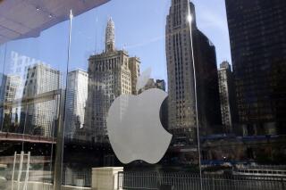 FILE - In this Thursday, Oct. 19, 2017, file photo, buildings are reflected behind the logo at an Apple Store in downtown Chicago. Apple Music is coming to a city near you — the streaming service launched daily music charts focused on particular cities around the world on Monday, April 26, 2021. (AP Photo/Kiichiro Sato, File)