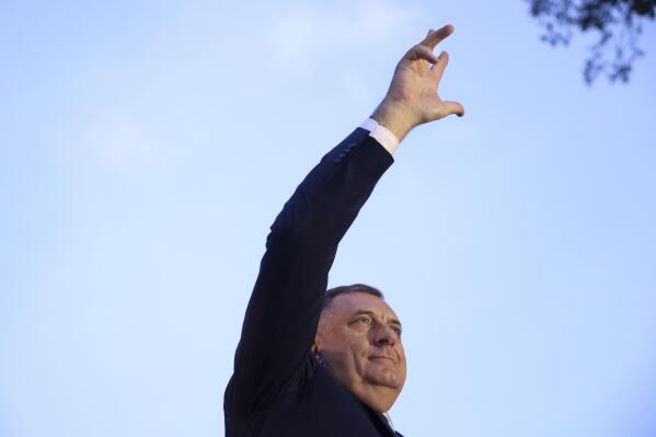 Bosnian Serb leader and member of the Bosnian Presidency Milorad Dodik waves with three fingers to the crowd of thousands who gathered to support the "people's rally for the defense of Republika Srpska" protest in Banja Luka, Bosnia, Tuesday, Oct. 25, 2022. Tens of thousands of people rallied in Bosnia Tuesday to demand from electoral authorities to end a recount of ballots cast in one of the races in the country’s Oct. 2 general election and confirm a staunchly pro-Russian politician as the president of its Serb-run part.(AP Photo/Armin Durgut)