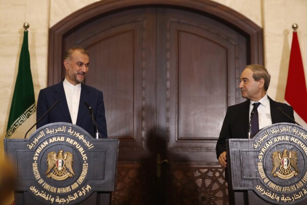 Syrian Foreign Minister Faisal Mekdad, right, speaks with Iranian Foreign Minister Hossein Amirabdollahian during a joint press conference in Damascus, Syria, Monday, April 8, 2024. Iran's foreign minister Monday accused the United States of giving Israel the