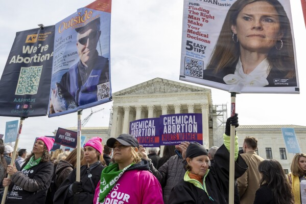 FILE - Anti-abortion and Abortion-rights activists rally outside the Supreme Court, Tuesday, March 26, 2024, in Washington. Two years after a leaked draft of a U.S. Supreme Court opinion singled that the nation's abortion landscape was about to shift dramatically, the issue is still consuming the nation's courts, legislatures and political campaigns and changing the course of lives. (AP Photo/Amanda Andrade-Rhoades, File)