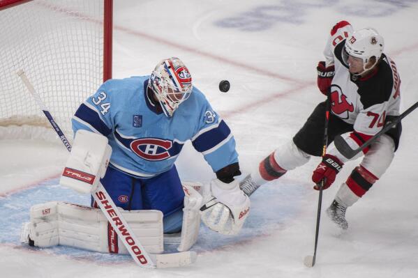 New Jersey Devils' Jesper Boqvist moves in on Montreal Canadiens goaltender Jake Allen during the second period of an NHL hockey game, Tuesday, Nov. 15, 2022 in Montreal. (Graham Hughes/The Canadian Press via AP)