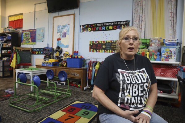Goldie Huff speaks about at her experience bringing her children, grandchildren and foster care children to child care during the day while she waits tables at a local steakhouse at Living Water Child Care and Learning Center in Williamson, W.Va. on Monday, Sept. 25, 2023. (AP Photo/Leah Willingham)