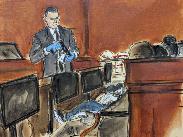 Special agent Gerard Gannon shows the jury a hand gun recovered from Sean "Diddy" Combs' Star Island residence during Combs' sex trafficking and racketeering trial in Manhattan federal court, Wednesday, May 21, 2025, in New York. (Elizabeth Williams via AP)