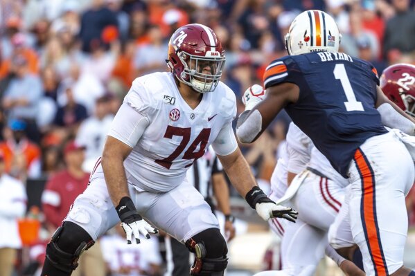 FILE - In this Nov. 30, 2019, file photo, Alabama offensive lineman Jedrick Wills Jr. (74) sets up to block against Auburn defensive lineman Big Kat Bryant (1) during the first half of an NCAA college football game in Auburn, Ala. Wills allowed one sack in 39 college games, playing exclusively at right tackle. (AP Photo/Vasha Hunt, File)