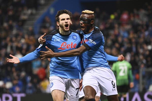 FILE - Napoli's Khvicha Kvaratskhelia, left, celebrates with team mate Victor Asimhen after scoring during the Serie A soccer match between Sassuolo and Napoli, at the Mapei Stadium in Reggio Emilia, Italy, on Feb. 17, 2023. It's a celebration more than 30 years in the making, and historically superstitious Napoli fans are already painting the city blue in anticipation of the team's first Italian league title since the days when Diego Maradona played for the club. (Massimo Paolone/LaPresse via AP)