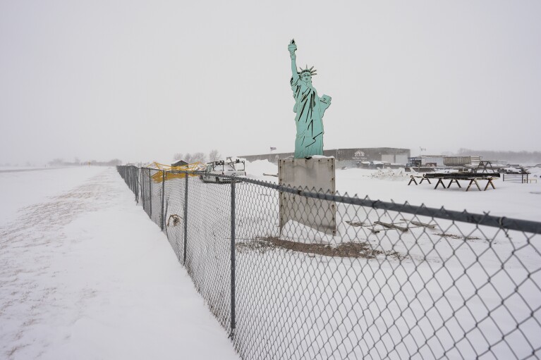 A sculpture of the Statue of Liberty that is part of a Creative Steel custom art display is seen at Port Neal Welding Company in Salix, Iowa, during a winter storm, Friday, Jan. 12, 2024. (AP Photo/Carolyn Kaster)