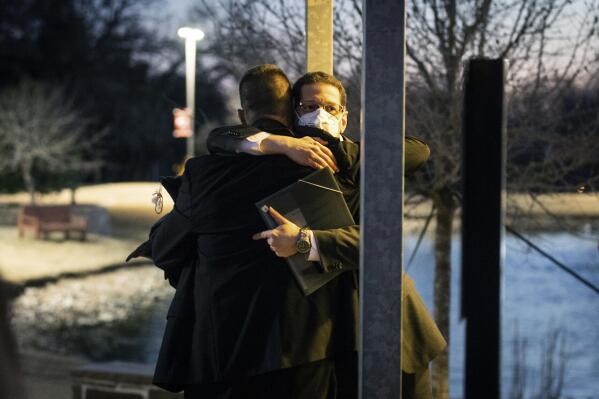 Congregation Beth Israel Rabbi Charlie Cytron-Walker, facing camera, hugs a man after a healing service Monday night, Jan. 17, 2022, at White’s Chapel United Methodist Church in Southlake, Texas. Cytron-Walker was one of four people held hostage by a gunman at his Colleyville, Texas, synagogue on Saturday. (Yffy Yossifor/Star-Telegram via AP)