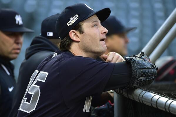 New York Yankees pitcher Gerrit Cole (45) watches batting practice before Game 3 of the baseball team's AL Division Series against the Cleveland Guardians, Saturday, Oct. 15, 2022, in Cleveland. (AP Photo/Phil Long)