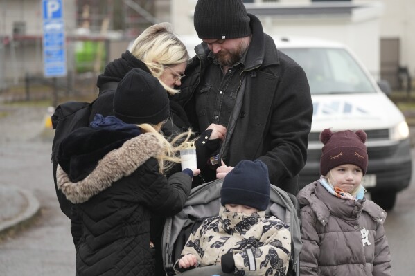 People light candles at a memorial near the scene of a shooting in the outskirts of Orebro, Sweden, on Wednesday, February 5th, 2025 (AP Photo/Sergei Grits)