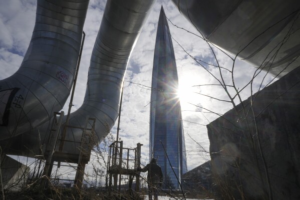 FILE - A man walks near the business tower Lakhta Centre, the headquarters of Russian gas monopoly Gazprom in St. Petersburg, Russia, on March 16, 2023. The European Commission said Friday Oct. 20, 2023 it is discussing with Bulgaria its introduction of a fee on Russian gas transits, a measure that has angered EU co-member Hungary as well as Serbia — both recipients of Russian gas. (AP Photo/Dmitri Lovetsky, File)