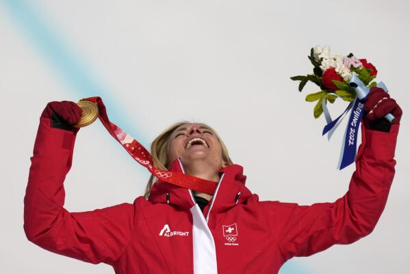 Lara Gut-Behrami, of Switzerland celebrates during the medal ceremony after winning the gold medal in the women's super-G at the 2022 Winter Olympics, Friday, Feb. 11, 2022, in the Yanqing district of Beijing. (AP Photo/Luca Bruno)