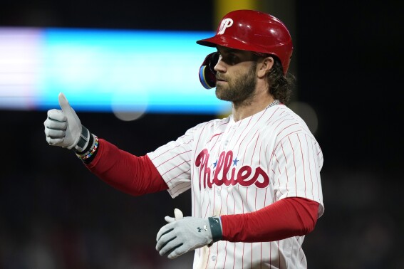 Philadelphia Phillies' Bryce Harper reacts after hitting a run-scoring single against New York Mets pitcher Grant Hartwig during the fifth inning of a baseball game, Sunday, Sept. 24, 2023, in Philadelphia. (AP Photo/Matt Slocum)