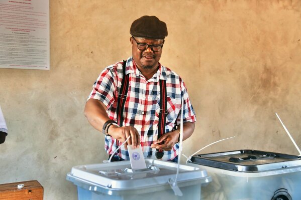 Chadema Presidential Candidate Tundu Lissu casts his vote at Ntewa Primary School's polling station in Ikungi town Singida region, Tanzania, Wednesday. Oct.28, 2020. Opposition challenger Lissu has urged people to go into the streets to protest if election results are announced Thursday without being counted properly. (AP Photo)