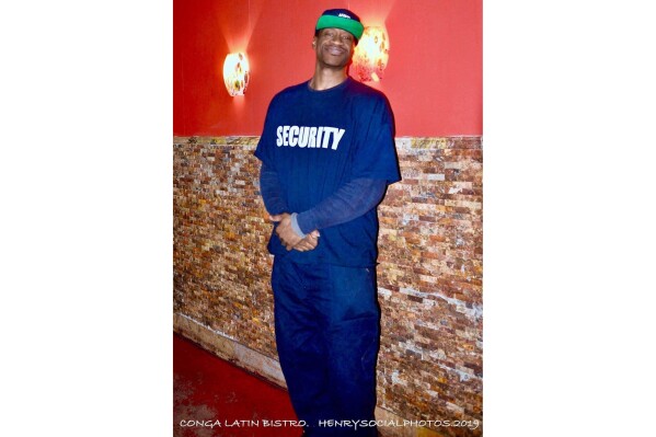 This Feb. 22, 2019 photo provided by Henry Giron shows George Floyd at Conga Latin Bistro in Minneapolis, where he worked in security. (HenrySocialPhotos via AP)