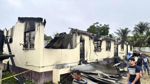 In this photo provided by Guyana's Department of Public Information, the dormitory of a secondary school is burned in Mahdia, Guyana, Monday, May 22, 2023. A nighttime fire raced through the dormitory early Monday, killing at least 19 students and injuring several others, authorities said. (Guyana's Department of Public Information via AP Photo)