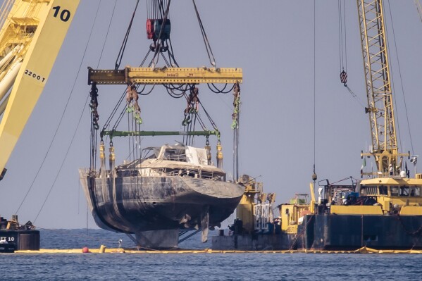 The hull of the superyacht Bayesian, which sank near Palermo, Sicily, on August 19, 2024, is pulled out of the sea off the village of Porticello and dewatered, Saturday, June 21, 2025. (AP Photo/Salvatore Cavalli)