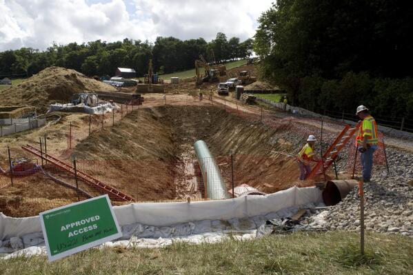 FILE - Construction crews are boring beneath U.S. 221 in Roanoke County, Va., to make a tunnel through which the Mountain Valley Pipeline will pass under the highway, seen on Friday, June 22, 2018. The U.S. Forest Service has reissued approval for the controversial and long-delayed natural gas pipeline to run through Jefferson National Forest in Virginia and West Virginia. The decision Monday, May 15, 2023, will allow for construction of the $6.6 billion Mountain Valley Pipeline across a 3.5-mile corridor of the national forest. (Heather Rousseau/The Roanoke Times via AP, File)